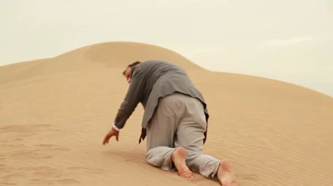 Exhausted businessman crawling in the desert Stock Footage