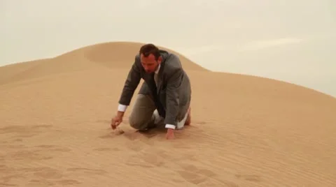 Exhausted businessman crawling in the desert HD Stock Footage