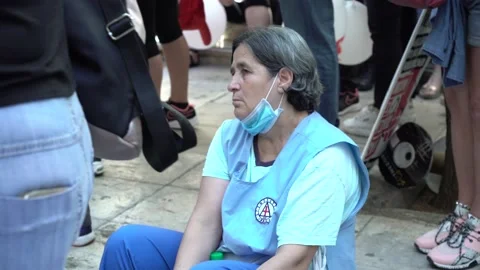 An exhausted cleaning lady falling asleep during a protest of health workers Stock Footage 142953448
