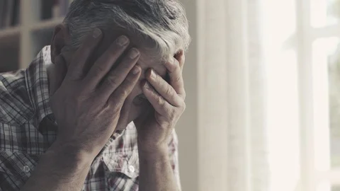 Exhausted concerned man with head in hands Stock Footage 103203116