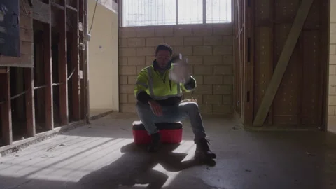 Exhausted Construction Man Sits On Toolbox At Work Stock Footage 270391492
