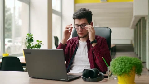 Exhausted customer support service worker removes headphones, finishes work Stock Footage 220726128