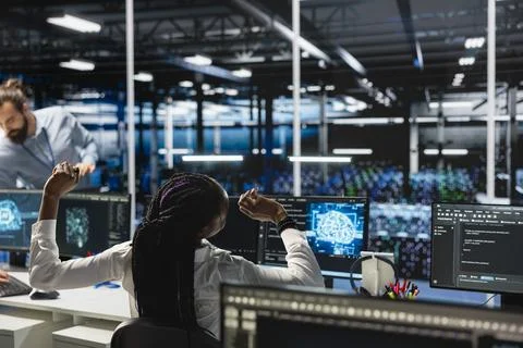 Exhausted data center female programmer stretching to ease back tension Stock Photos