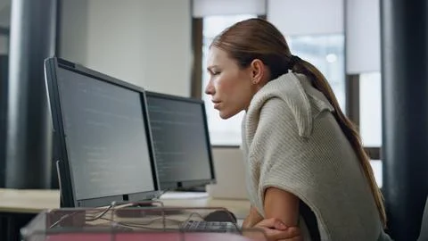 Exhausted developer working office alone. Stressed woman rubbing head searching 스톡 사진
