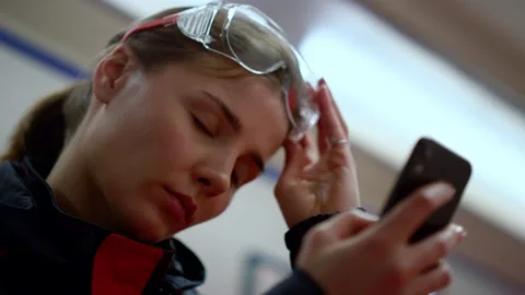 Exhausted doctor using mobile phone. Professional paramedic feeling tired 스톡 동영상 166887757