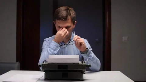 An exhausted editor working under dim lamp, ambient scene of tired proofreader Video stock 320742966