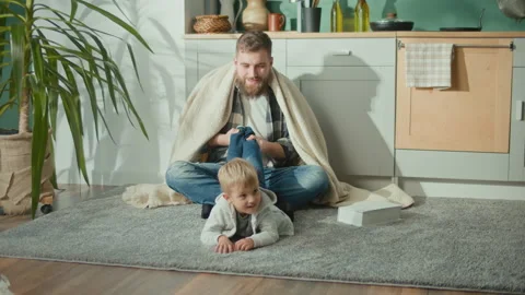 Exhausted Father Sitting With His Hyperactive Child. Super Dad Stock Footage 194599419
