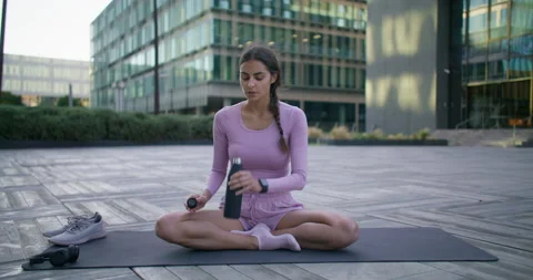 Exhausted fitness model drinks water for hydration after cardio training takes Stock Footage 159727300