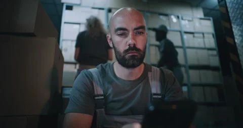 Exhausted Loader Using Smartphone, Having Rest after Hard Workday in Logistics Stock Footage 313346560