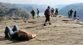 Exhausted man after walking to the Preacher Pulpit Rock Vídeos en HD
