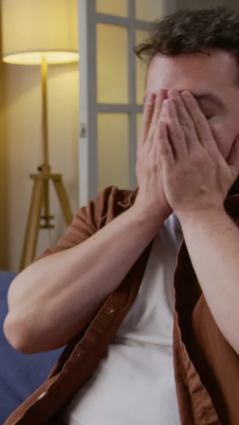 Exhausted Man Closing Computer and Rubbing Eyes Vertical Stock Footage 327686947