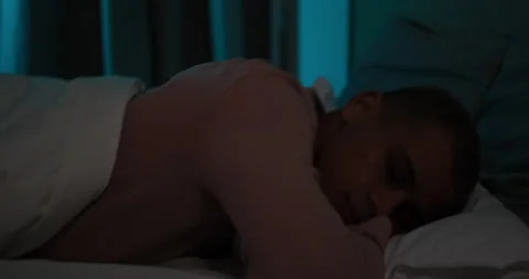 Exhausted man falling asleep on bed Video stock 145289555