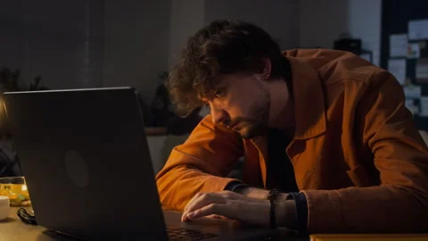 Exhausted Man Falling Asleep on Laptop Working Late in Office Stock Footage 338417563