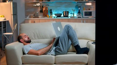 Exhausted man falling asleep while working on internet communication project 스톡 사진