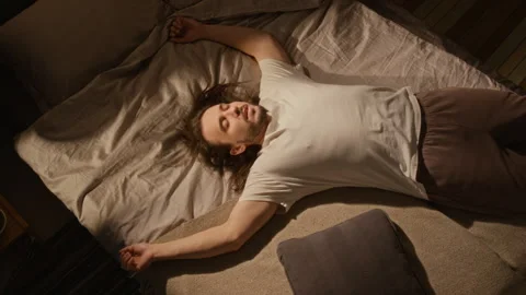 Exhausted Man Falling Backwards on Bed after Working at Home Stock Footage 337499385