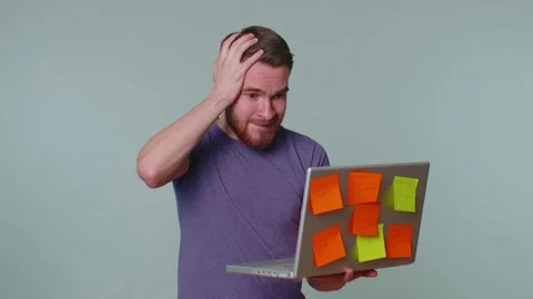 Exhausted man freelancer with pasted sticker notes using laptop computer Stock Footage 170633690