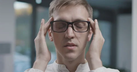 Exhausted man massaging his temples Stock Footage 168371794