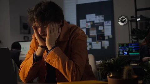 Exhausted Man Rubbing Temples and Working Late on Laptop at Night Stock Footage 338418139