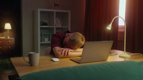 Exhausted man sleep at work lie desk near laptop. Tired sleepy lazy person. Stock Footage 326853611
