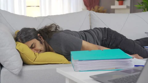 Exhausted man throws himself on the sofa. Stock Footage 221686002