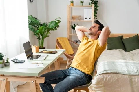 Exhausted man while working from home. Stock Photos
