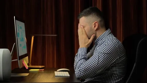 Exhausted man working at home on desktop computer Stock Footage 166499512