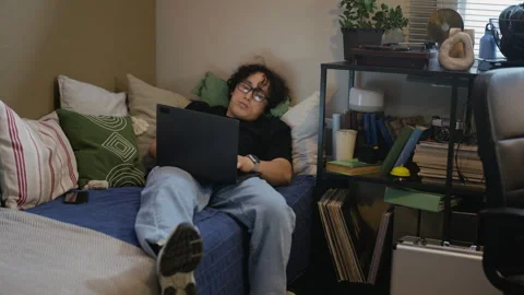 Exhausted Man Working on Laptop While Lying down at Home Stock Footage 338424604