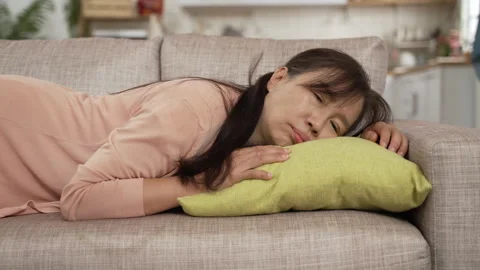 Exhausted middle aged female falling on couch Video stock 250379597