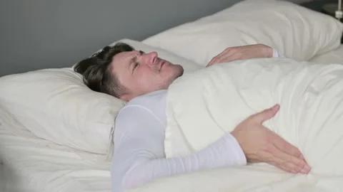 Exhausted Middle Aged Man with Back Pain Laying in Bed 스톡 동영상 142370868