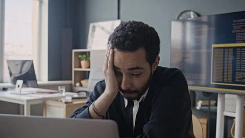 Exhausted Middle Eastern Office Employee Feeling Stressed Working on Laptop Stock Footage 337486704