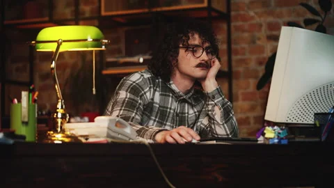 Exhausted nerdy guy from 90s falling asleep while working on computer in office Stock-Footage 321072648