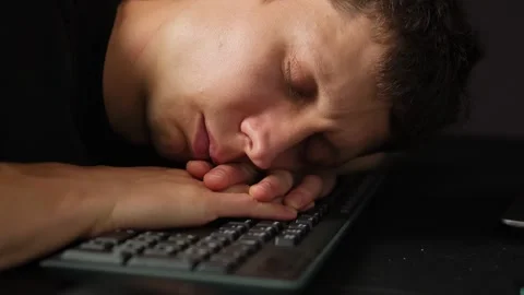 Exhausted office worker falling asleep on keyboard late at night burnout and Stock Footage 317997828
