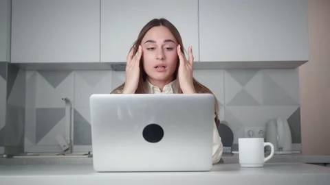 Exhausted office worker pretty young girl is using laptop then touching head Stock Footage 168034642