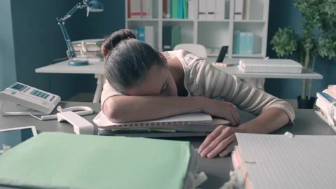 Exhausted office worker sleeping on the desk Stock Footage 133401484