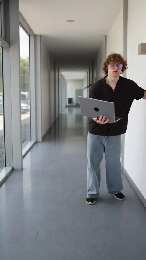 Exhausted office worker walks with laptop after overwhelming workday Stock Footage 337850840