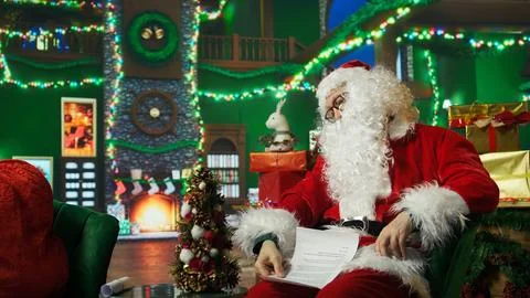Exhausted old man falling asleep while reading children Christmas wish lists Stock Photos