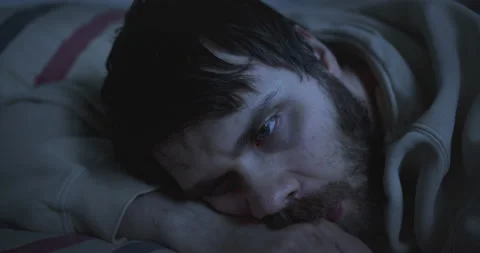 Exhausted, pensive man in deep depression lying on the bed. Unkempt. Stock Footage 139781407