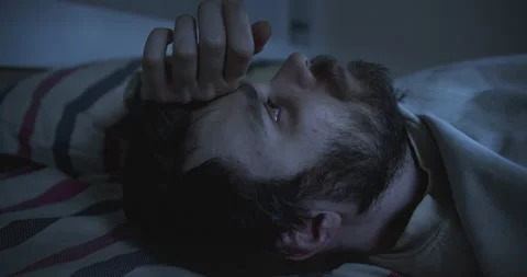 Exhausted, pensive man in deep depression lying on the bed. Unkempt. Stock Footage 139782329