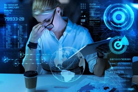 Exhausted programmer closing her eyes while sitting at work Stock Photos