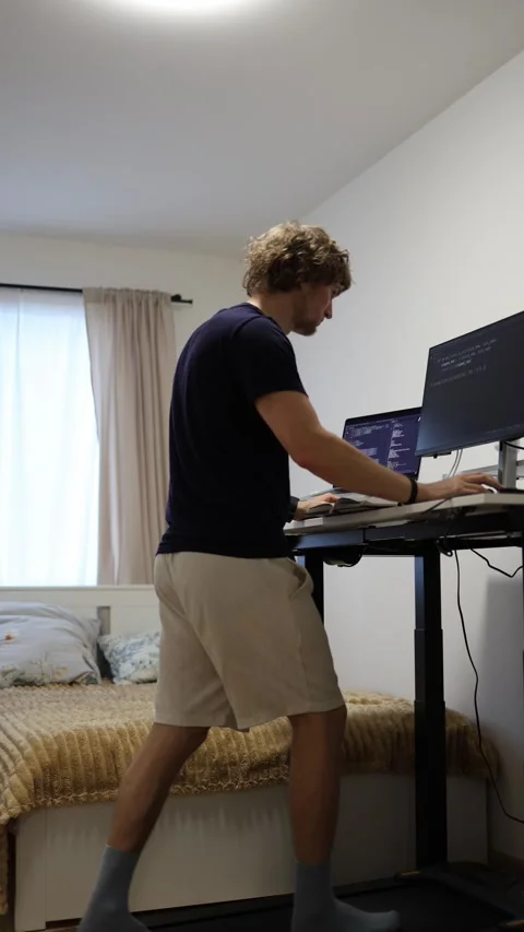 Exhausted programmer falls asleep while working and walking on treadmill Stock-Footage 346881402