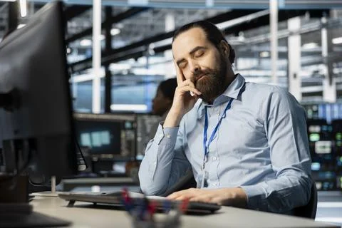 Exhausted server hub worker falling asleep at desk 写真素材