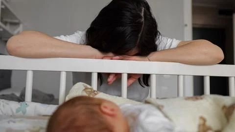 Exhausted single mother coping with postpartum depression Stock Photos