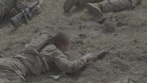 An exhausted soldier performing a leopard crawl while carrying a weapon Stock Footage 295033787