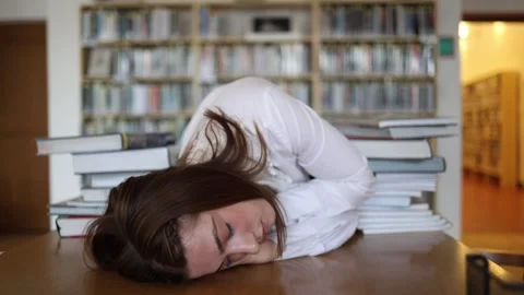 Exhausted student falls asleep after hours of intense studying Stock Footage 341656419
