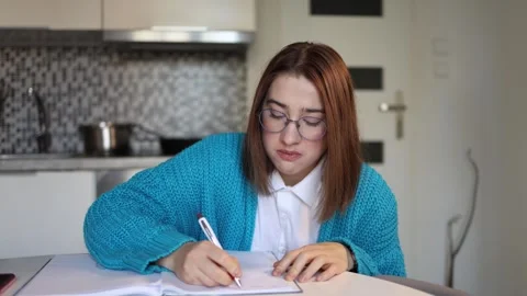 Exhausted student forces herself to finish university work Stock Footage 328043032