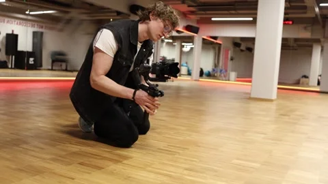 Exhausted videomaker takes a break Stock Footage 332116837