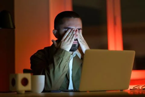 Exhausted web designer or manager work late overloaded alone in office use at Stock Photos