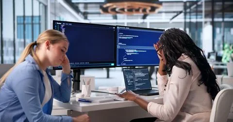 An Exhausted Woman Struggles With Coding Problems Late At Night. Stock Photos