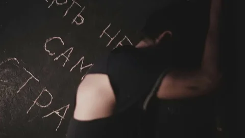 Exhausted young guy trying to get out of a terrible room Stock Footage 76605018