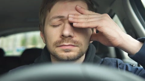 Exhausted young man driver sitting in his car, feeling emotional burnout. Stock Footage 186272761